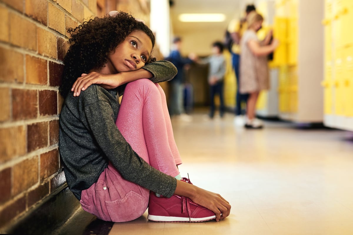 A young person in quiet reflection, representing low mood