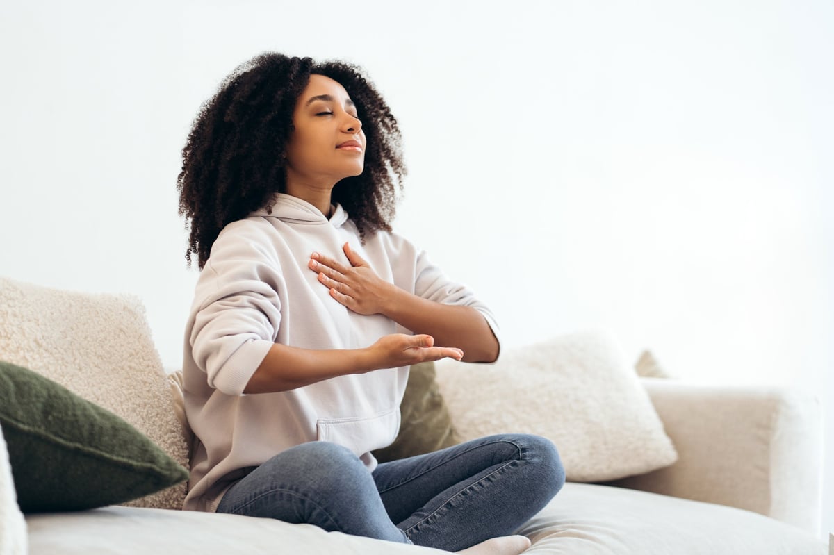 A woman practicing breathing exercises during a mindfulness session