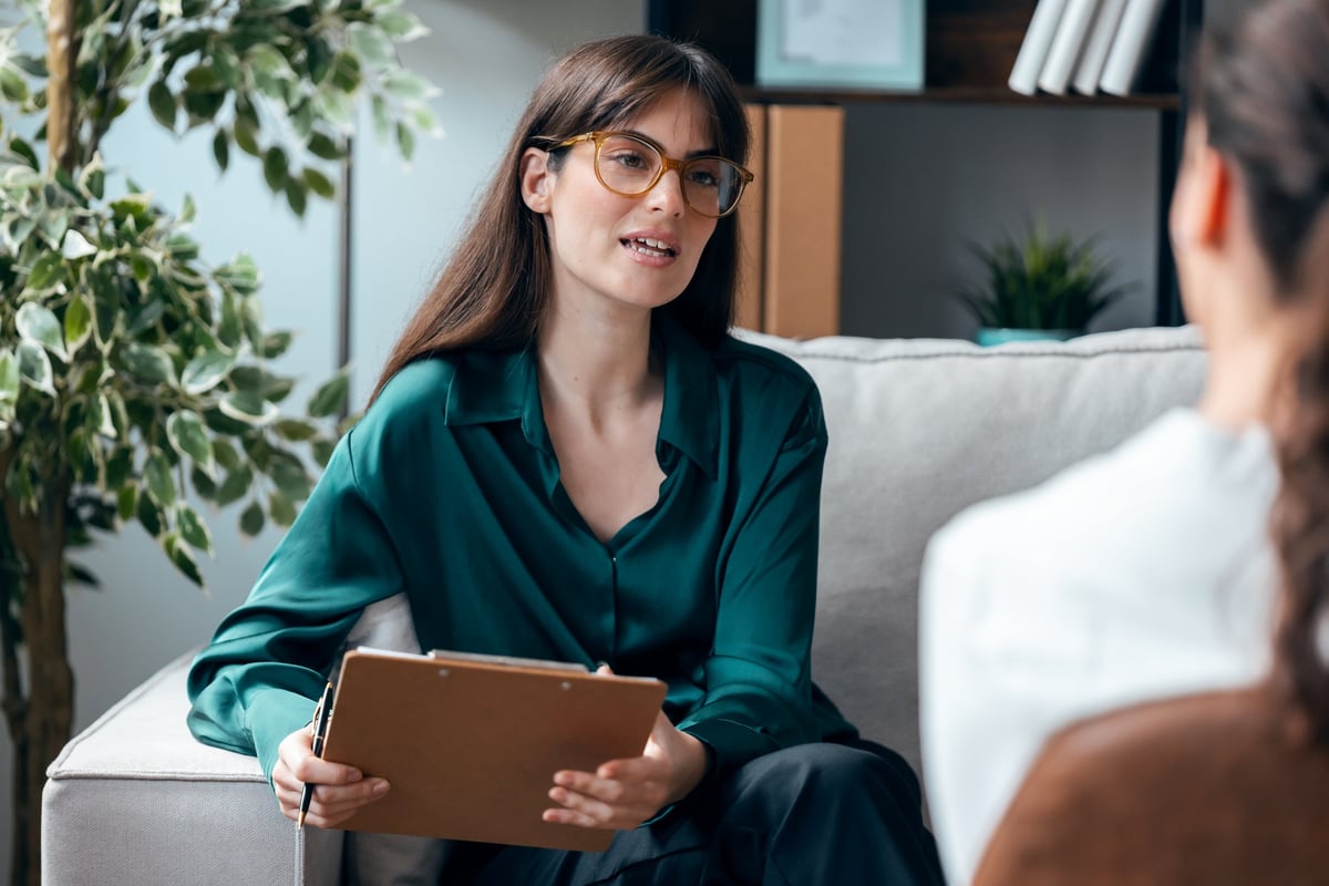 A therapist listening attentively to a client during a session