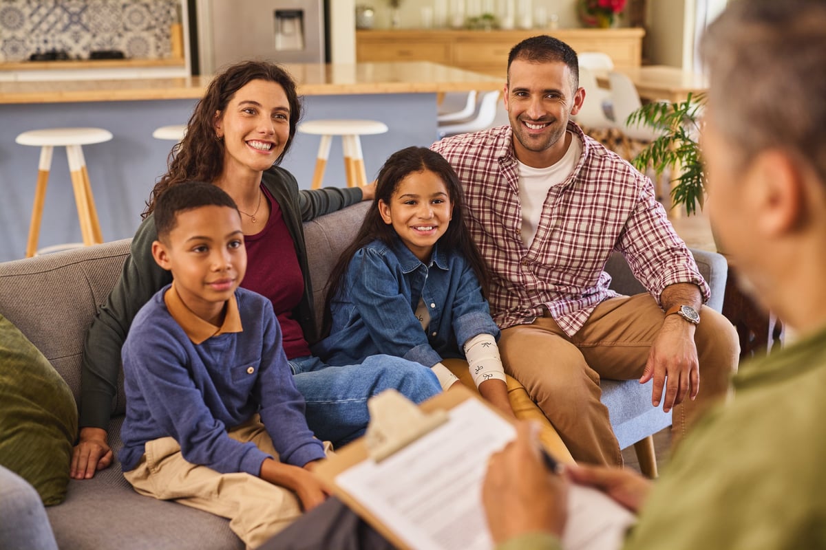 A family talking with their counselor during a supportive session